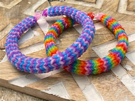 Rainbow <b>Loom</b> <b>bracelets</b> should be made by stretching a rubber band diagonally from the first center peg to the first left. . Loom bracelets